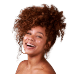 Woman with red curly hair in pineapple ponytail